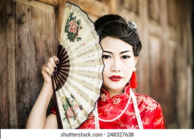 China Girl,Chinese Woman Red Dress Traditional Cheongsam ,close Up Portrait With Old Wood Door