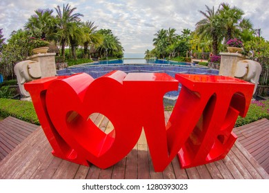 China, Hainan Island, Sanya bay - January 3, 2019. Celebration of St. Valentine's Day on the tropical islands. luxury vacation. Inscription love on the background of exotic palms .