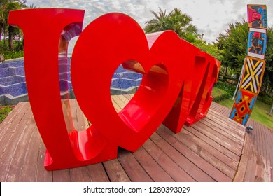 China, Hainan Island, Sanya bay - January 3, 2019. Celebration of St. Valentine's Day on the tropical islands. luxury vacation. Inscription love on the background of exotic palms .