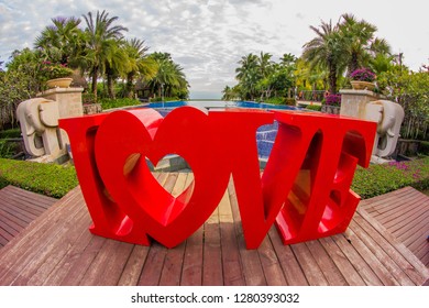 China, Hainan Island, Sanya bay - January 3, 2019. Celebration of St. Valentine's Day on the tropical islands. luxury vacation. Inscription love on the background of exotic palms .
