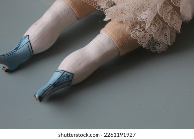 China head doll legs with blue china shoes and lace outfit