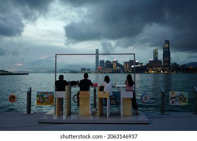 China Hong Kong 14 Jun 2021 Wan Chai Western Harbour A Group Of Friends Gathering With Beers, Chatting If Front Of The Sea With Brilliant View 