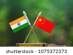China and India small flag with blur green background