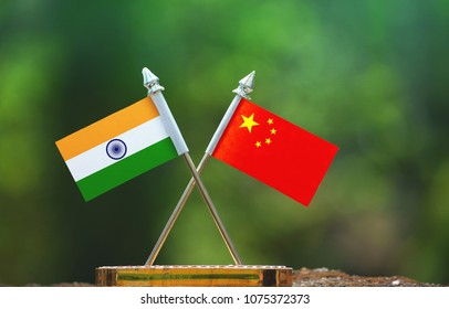 China And India Small Flag With Blur Green Background