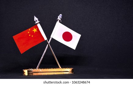 China And Japan Table Flag With Black Background