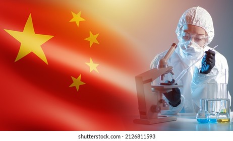 China Laboratory. Chemical Research In China. Chemist Next To Chinese Flag. Researcher With Test Tube In His Hand. Chinese Scientist In Front Of Microscope. Chemical Laboratory At PRC