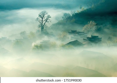 China Old City Town Anhui Landscape. Ancient Traditional Chinese Architecture Houses In Fog View. Peaceful Green Trees And Small Rural Village. Rustic Background Image.