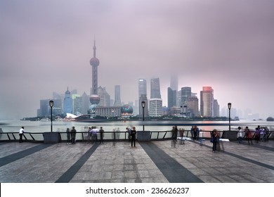 China SHanghai Pudong CBD Sunset View Over River Illuminated Skyscrapers And Towers Covered By Pollution Smog