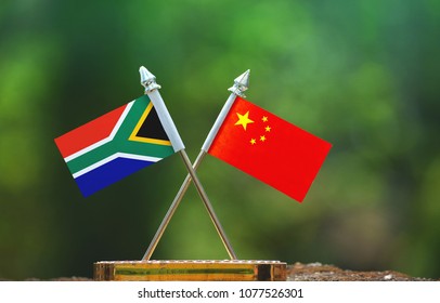 China and South Africa small flag with blur green background