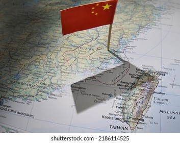 China  Taiwan August 2022. Editorial style graphic showing the Chinese flag on a map casting a shadow from it's territory over Taiwan and the disputed Taiwanese Strait. 