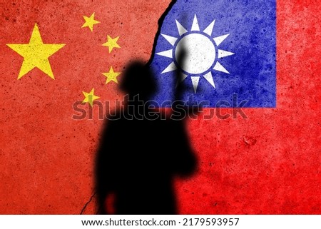 China and Taiwan flags painted on a concrete wall with soldier shadow