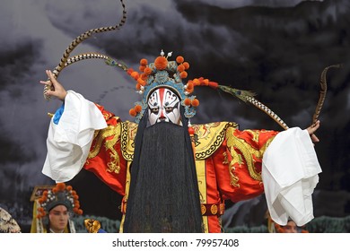 china traditional opera actor performs on stage with theatrical costume and facial painting