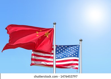 China And Usa National Flag Waving Against Sunny Blue Sky Side View Of Natural Color Of People Republic Of China And United States Of America Us State Symbols Isolated For Design Copy Space Template