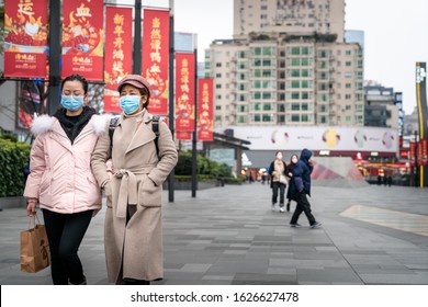 CHINA,CHENGDU,Chunxi Rd.-JANUARY 23,2020: Coronavirus Epidemic In China .People Wearing Face Masks. Novel Coronavirus (2019-nCoV), People In White Medical Face Mask