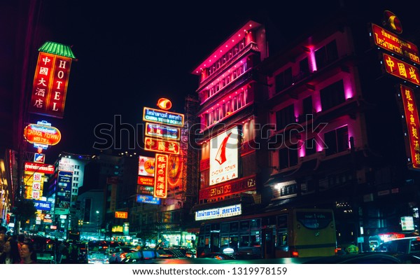 CHINATOWN, BANGKOK, THAILAND - 19 FEB 2019 - Neon\
light signs and cars on Yaowarat road at night main street of China\
town.