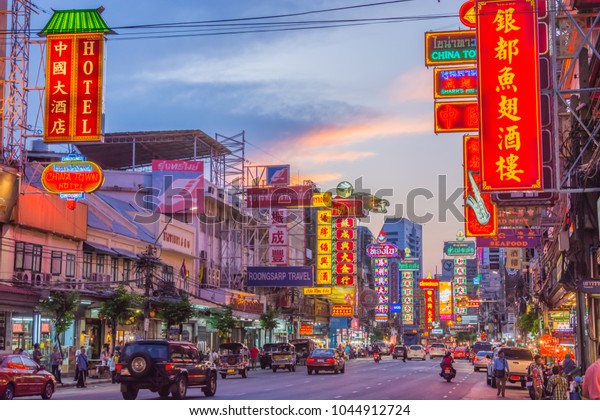 Chinatown, Bangkok, Thailand - March 31\
, 2015: Cars and shops with neon board signs on Yaowarat road,\
Chinatown with Chinese buildings, restaurants and decoration in the\
evening of\
Bangkok,Thailand.