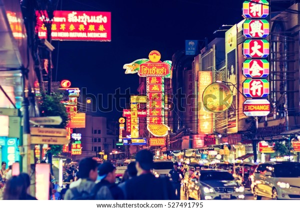 Chinatown\
Bangkok, Thailand - November 28, 2016: Cars and shops on Yaowarat\
Road in the evening the main street of\
town.