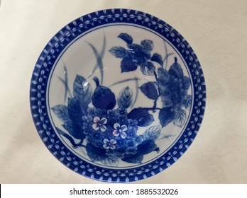chinaware ceramic, old bowl porcelain decorated with blue and white pigments, cobalt oxide, drawing flowers or patterns