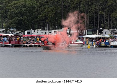 CHINCOTEAGUE, VIRGINIA - JULY 25, 2018: Coast Guard Gives The Start Signal For The Pony Swim. Wild Ponies Swim To Chincoteague Island From Assateague Island. This Is An Event To Raise Money. 