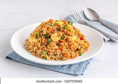 Chinese Asian Egg and Vegetable Fried Rice on a White Plate on the White Background. - Shutterstock ID 1507919045