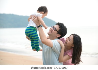 Chinese Asian Family Playing On The Beach 