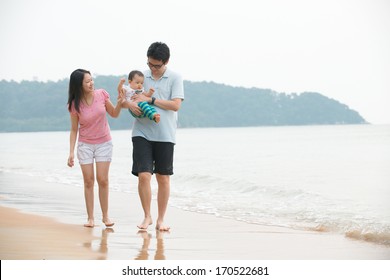 Chinese Asian Family Walking On The Beach