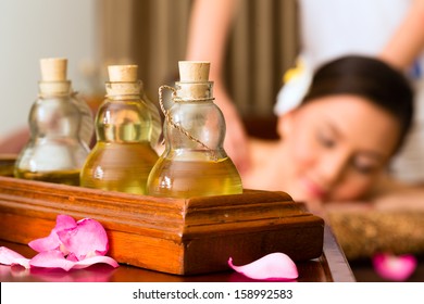 Chinese Asian Woman In Wellness Beauty Spa Having Aroma Therapy Massage With Essential Oil, Looking Relaxed