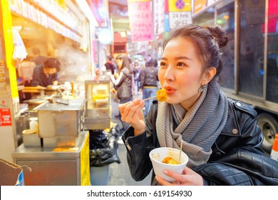 Chinese Asian Young Female Model Eating Chinese Steamed Dumpling On Street In Hong Kong