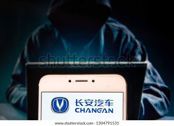 Chinese\
automobile manufacturer Changan logo is seen on an Android mobile\
device with a figure of hacker in the\
background.