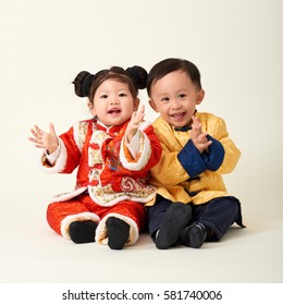 Chinese Baby Boy And Girl In Traditional Chinese New Year Outfit Celebrating Lunar New Year