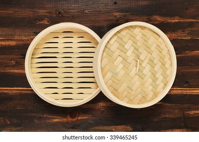 Chinese Bamboo Steamer Top View. On Brown Wooden Background.