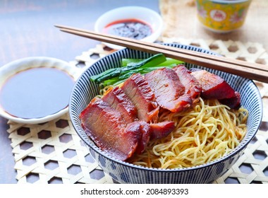 Chinese barbecue roast pork noodle (Char Siu) in a bowl - close up view of Asian food