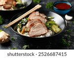 Chinese BBQ Pork Char Siu with rice and bok choy in a black bowl.