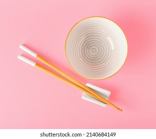 Chinese bowl with chopsticks on color background - Powered by Shutterstock