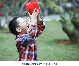 Chinese Boy Playing Red Lantern In Chinese Lunar New Year