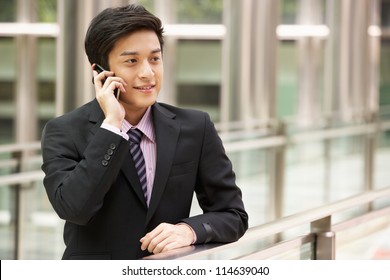 Chinese Businessman Outside Office On Mobile Phone