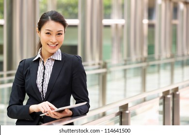 Chinese Businesswoman Working On Tablet Computer Outside Office