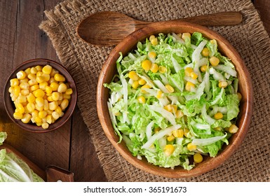 Chinese Cabbage Salad With Sweet Corn In A Wooden Bowl. Top View
