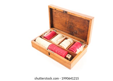 A Chinese carved ivory backgammon set comprising: red and white counters and dice tumblers. Photographed on a white background