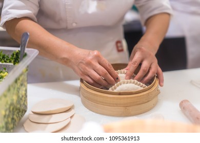 Chinese Chef Making Dumplings In Kitchen