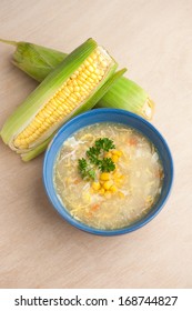 Chinese Chicken And Corn Soup With Fresh Corn Cob On The Side.