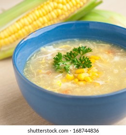 Chinese Chicken And Corn Soup With Fresh Corn Cob On The Side.