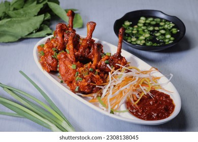 Chinese Chicken Lollypop garnished in a white plate.