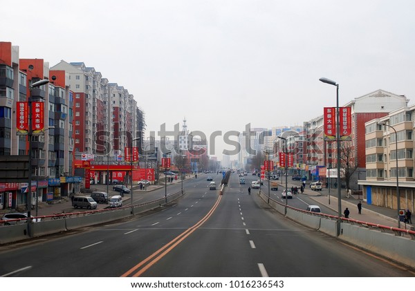 CHINESE.  THE\
CITY OF CHANGCHUN - DEC,12 2008. road on the outskirts of the city\
early this morning cloudy. the people walking the streets, along\
the road small new high-rise\
build