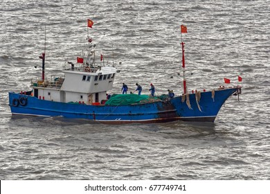 Chinese Commercial Fishing Trawler Boat On The South China Sea Surrounded By Gulls