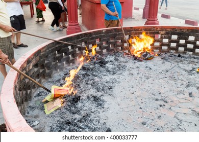 Chinese devotees burning paper offerings during QingMing celebration at temple