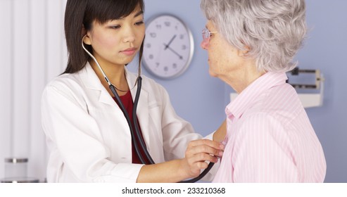 Chinese Doctor Listening To Elderly Patient's Heart