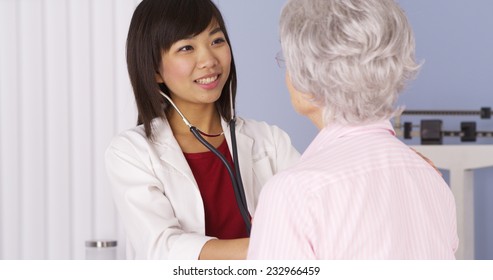 Chinese Doctor Listening To Senior Patient's Heart