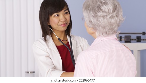 Chinese Doctor Listening To Senior Patient's Heart