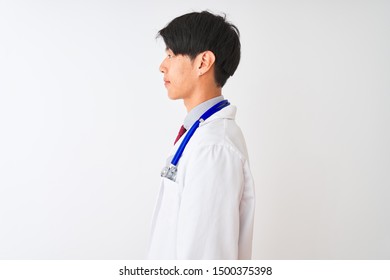 Chinese Doctor Man Wearing Coat Tie And Stethoscope Over Isolated White Background Looking To Side, Relax Profile Pose With Natural Face With Confident Smile.